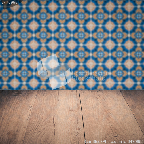 Image of Wood table top and blur vintage ceramic tile pattern wall