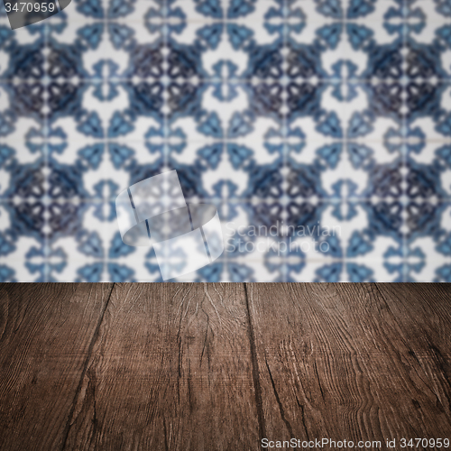 Image of Wood table top and blur vintage ceramic tile pattern wall