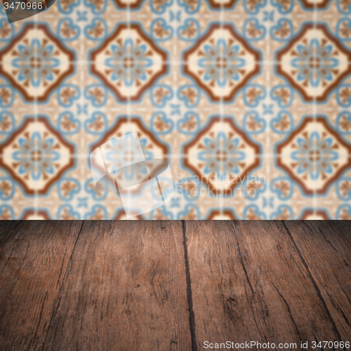 Image of Wood table top and blur vintage ceramic tile pattern wall