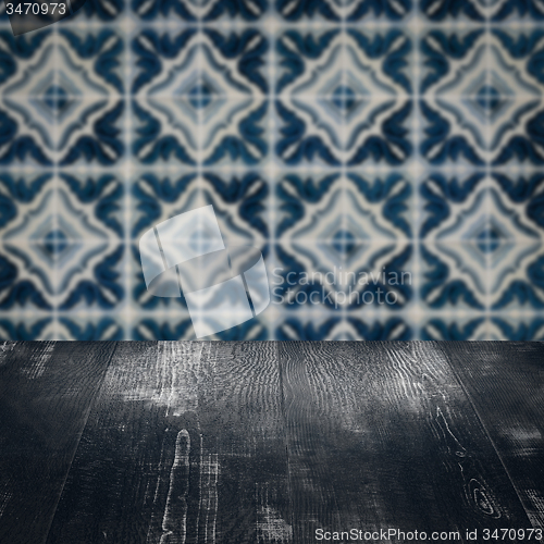 Image of Wood table top and blur vintage ceramic tile pattern wall