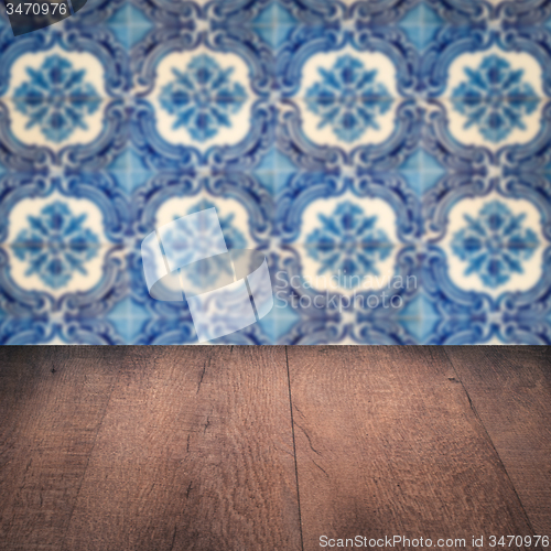 Image of Wood table top and blur vintage ceramic tile pattern wall