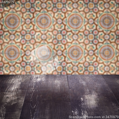 Image of Wood table top and blur vintage ceramic tile pattern wall
