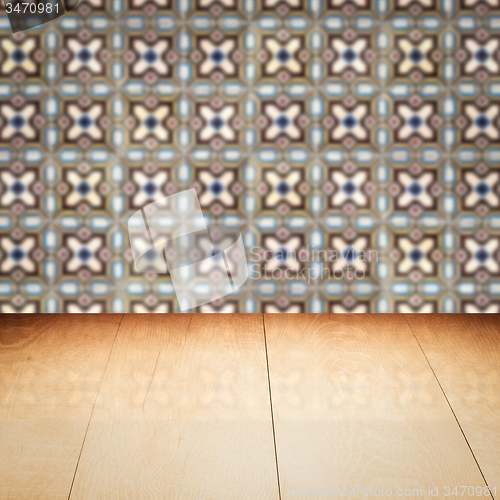 Image of Wood table top and blur vintage ceramic tile pattern wall