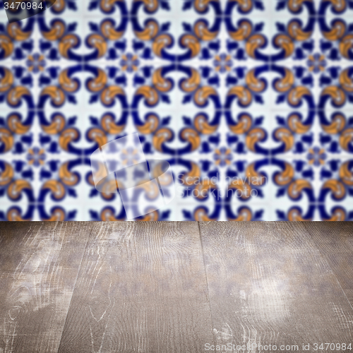 Image of Wood table top and blur vintage ceramic tile pattern wall