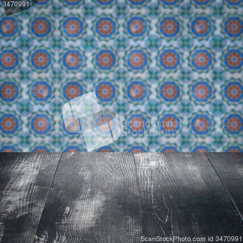 Image of Wood table top and blur vintage ceramic tile pattern wall