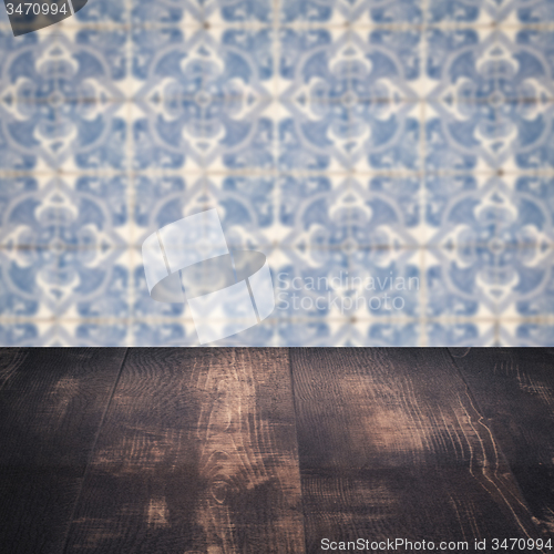 Image of Wood table top and blur vintage ceramic tile pattern wall