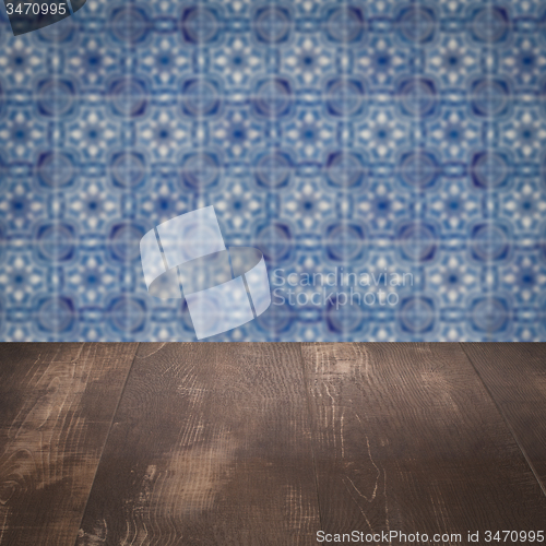 Image of Wood table top and blur vintage ceramic tile pattern wall