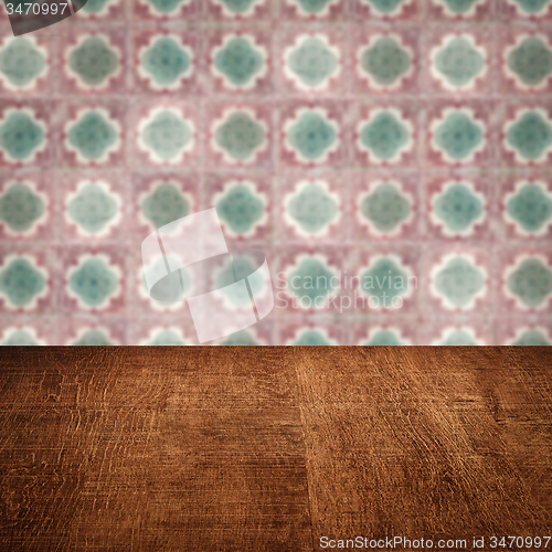Image of Wood table top and blur vintage ceramic tile pattern wall