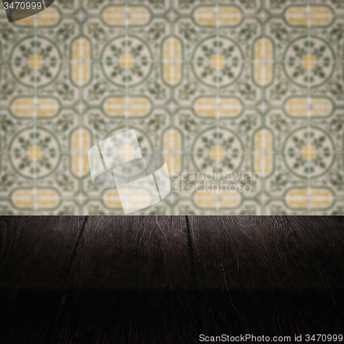 Image of Wood table top and blur vintage ceramic tile pattern wall