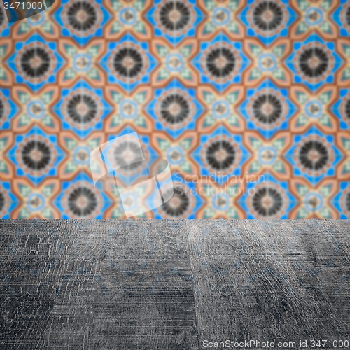 Image of Wood table top and blur vintage ceramic tile pattern wall