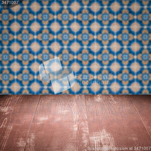 Image of Wood table top and blur vintage ceramic tile pattern wall