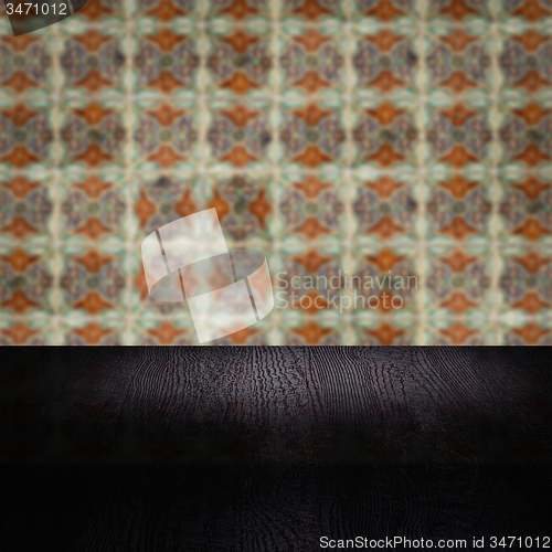 Image of Wood table top and blur vintage ceramic tile pattern wall