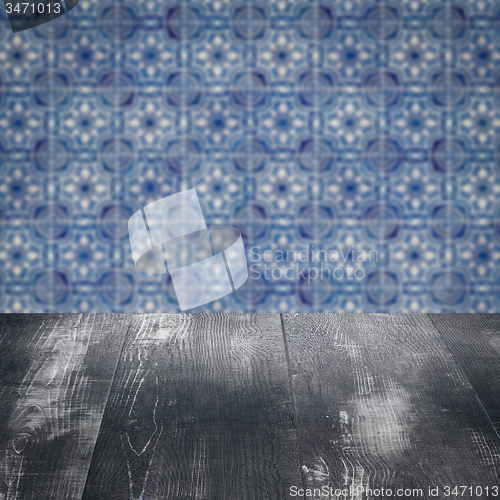 Image of Wood table top and blur vintage ceramic tile pattern wall