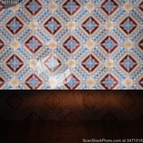 Image of Wood table top and blur vintage ceramic tile pattern wall