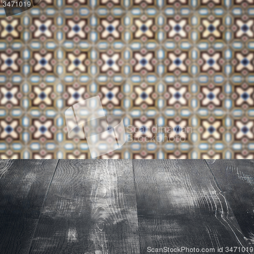 Image of Wood table top and blur vintage ceramic tile pattern wall