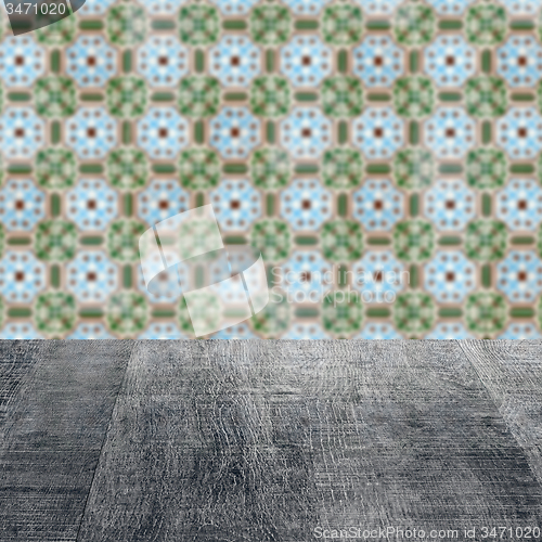 Image of Wood table top and blur vintage ceramic tile pattern wall