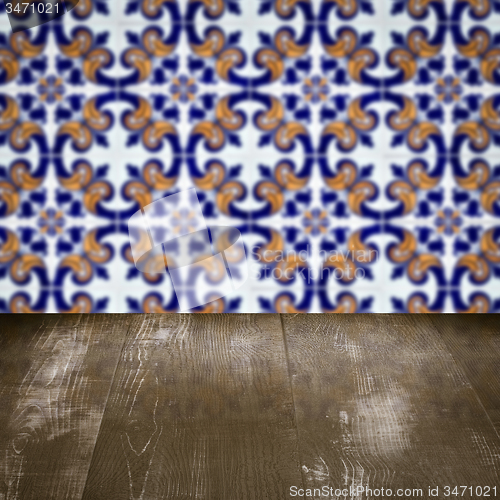 Image of Wood table top and blur vintage ceramic tile pattern wall