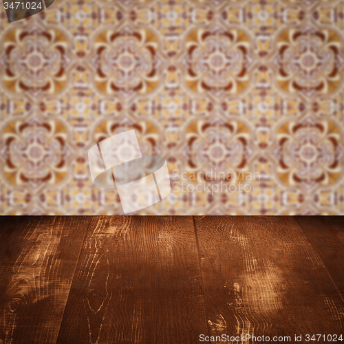 Image of Wood table top and blur vintage ceramic tile pattern wall