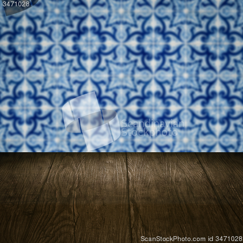 Image of Wood table top and blur vintage ceramic tile pattern wall