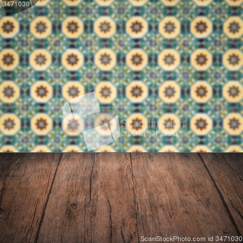 Image of Wood table top and blur vintage ceramic tile pattern wall