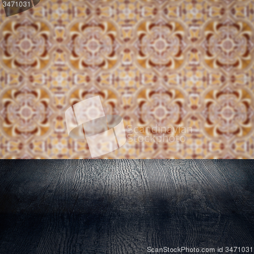 Image of Wood table top and blur vintage ceramic tile pattern wall