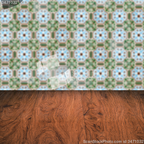 Image of Wood table top and blur vintage ceramic tile pattern wall