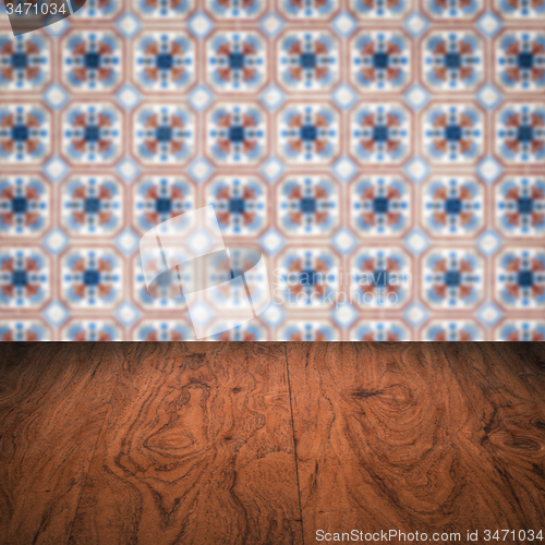 Image of Wood table top and blur vintage ceramic tile pattern wall