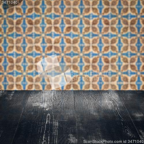 Image of Wood table top and blur vintage ceramic tile pattern wall