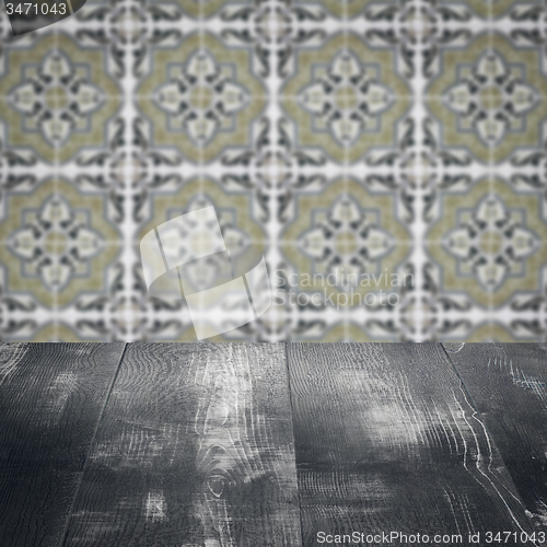 Image of Wood table top and blur vintage ceramic tile pattern wall