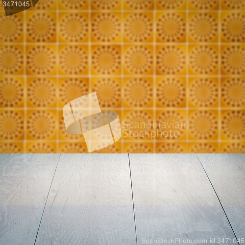 Image of Wood table top and blur vintage ceramic tile pattern wall