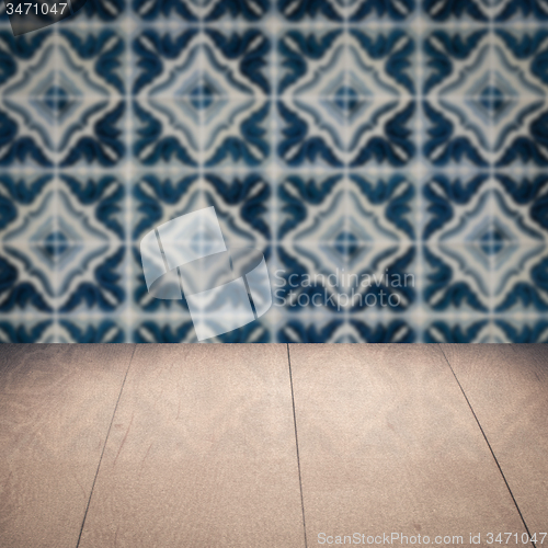 Image of Wood table top and blur vintage ceramic tile pattern wall