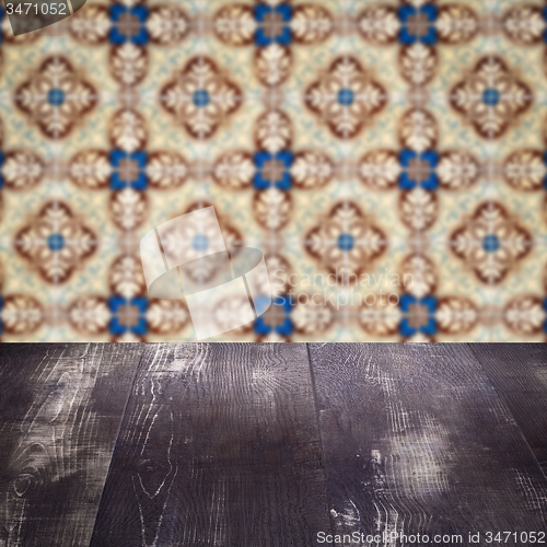Image of Wood table top and blur vintage ceramic tile pattern wall
