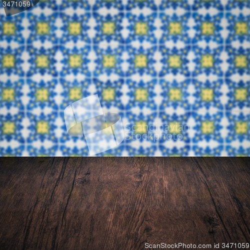 Image of Wood table top and blur vintage ceramic tile pattern wall