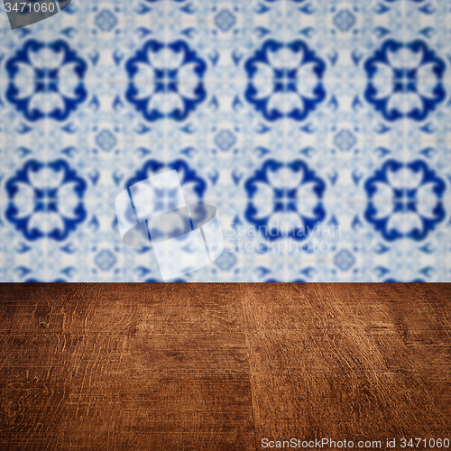 Image of Wood table top and blur vintage ceramic tile pattern wall