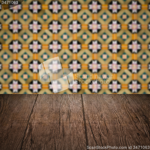 Image of Wood table top and blur vintage ceramic tile pattern wall