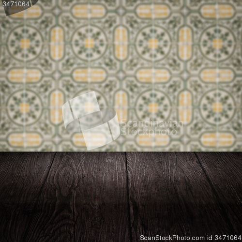 Image of Wood table top and blur vintage ceramic tile pattern wall