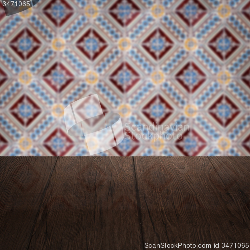 Image of Wood table top and blur vintage ceramic tile pattern wall
