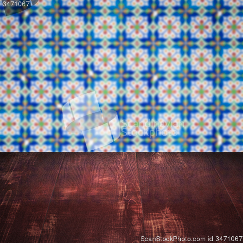 Image of Wood table top and blur vintage ceramic tile pattern wall