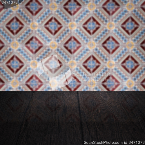 Image of Wood table top and blur vintage ceramic tile pattern wall