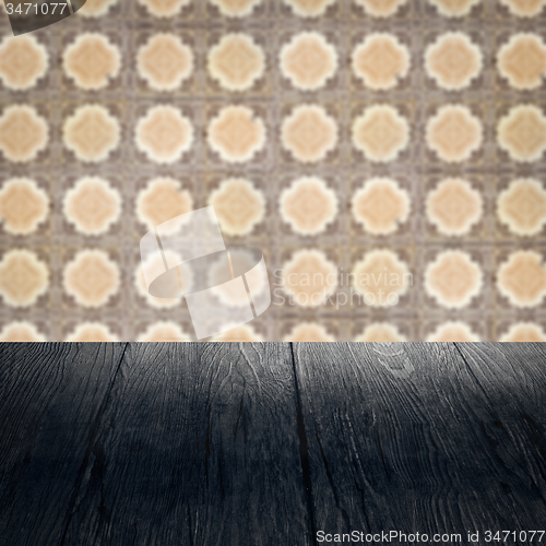 Image of Wood table top and blur vintage ceramic tile pattern wall