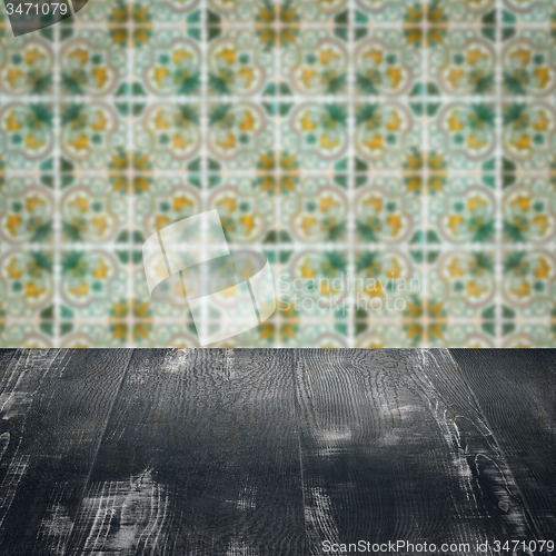 Image of Wood table top and blur vintage ceramic tile pattern wall
