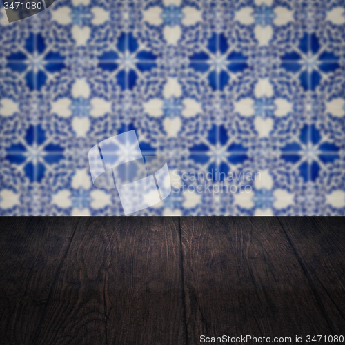 Image of Wood table top and blur vintage ceramic tile pattern wall