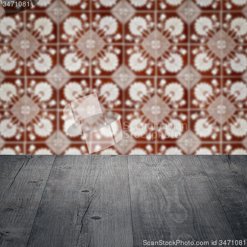 Image of Wood table top and blur vintage ceramic tile pattern wall