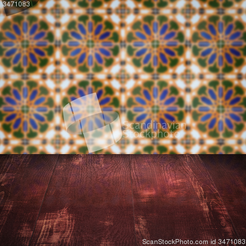 Image of Wood table top and blur vintage ceramic tile pattern wall