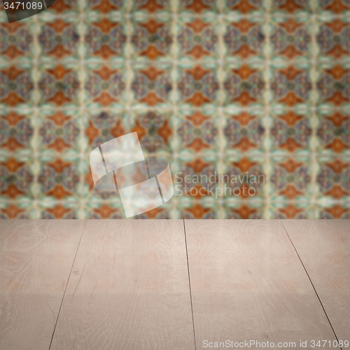Image of Wood table top and blur vintage ceramic tile pattern wall
