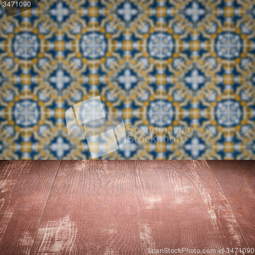 Image of Wood table top and blur vintage ceramic tile pattern wall