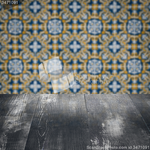 Image of Wood table top and blur vintage ceramic tile pattern wall