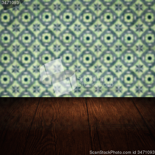 Image of Wood table top and blur vintage ceramic tile pattern wall
