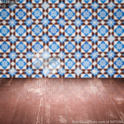 Image of Wood table top and blur vintage ceramic tile pattern wall