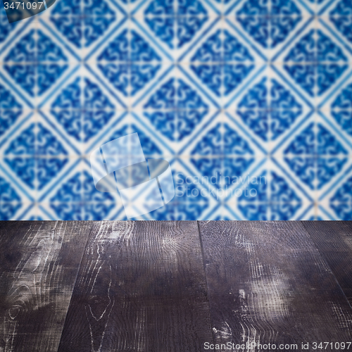 Image of Wood table top and blur vintage ceramic tile pattern wall